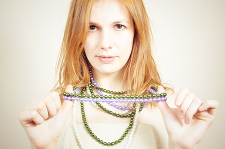 portrait of an attractive beautiful blond woman with a necklaceの写真素材