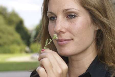 Young Woman holding a flower and smiling
