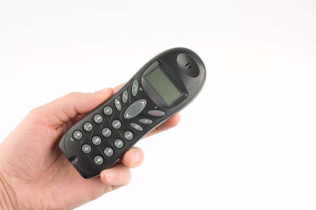 Wireless phone in the hand over white backgroundの写真素材