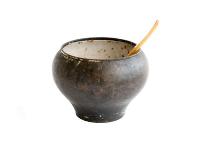 The cast-iron pot with spoon isolated over whiteの写真素材