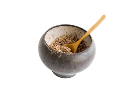 The cast-iron pot with spoon and boiled buckwheat isolated over whiteの写真素材