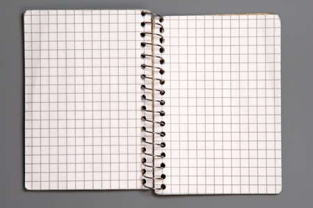 Open checked notebook isolated over grey backgroundの写真素材