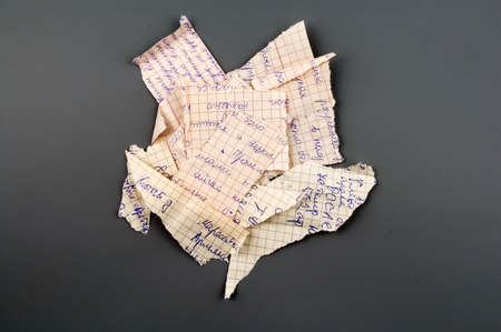 Small group of torn notebook paper isolated over greyの写真素材