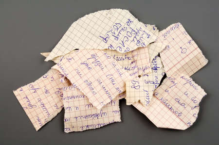 Small group of torn notebook paper isolated over greyの写真素材