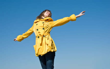 Happy female teenager on the sky background with room for textの写真素材