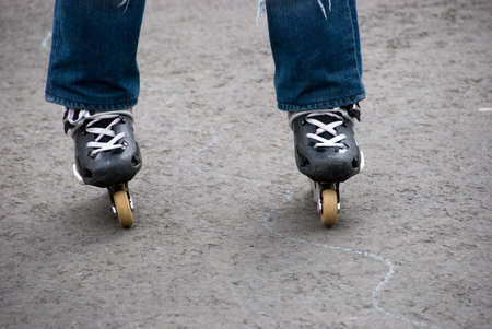 Roller-skater legs stand on asphaltの写真素材
