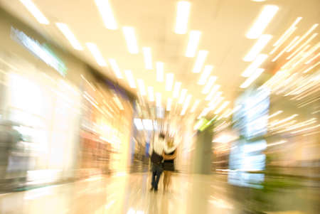 Couple in a mall. Blurred motion image