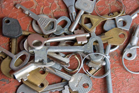 A lot of different keys over cracked red background