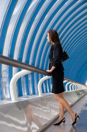 Business woman stands in modern business centerの写真素材
