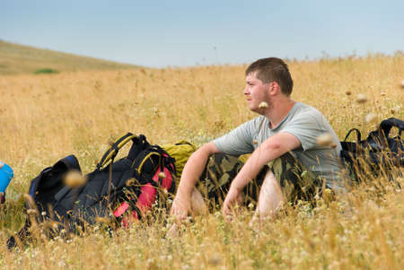Hiker has a rest on a hillsideの写真素材