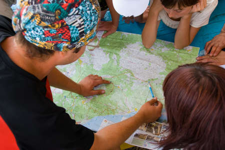 Hikers group planning path on the mapの写真素材