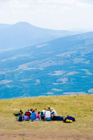 Hikers have a rest on a hillsideの写真素材