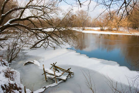 River in winter, coast are covered by snowの写真素材