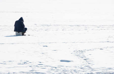 The fisherman on iceの写真素材