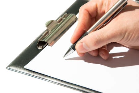 Pen in a hand ready for writing on a paper in clipboardの写真素材