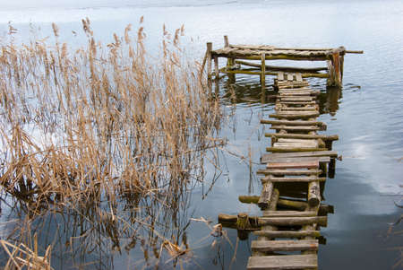 Wooden footbridge in a riverの写真素材