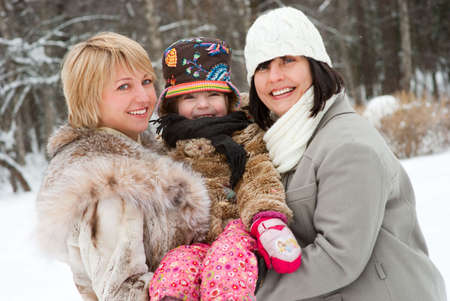 Happy women with daughter in winter outdoors