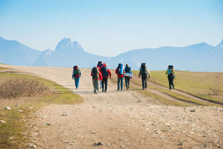 Hikers walk along the rocky footpathの写真素材