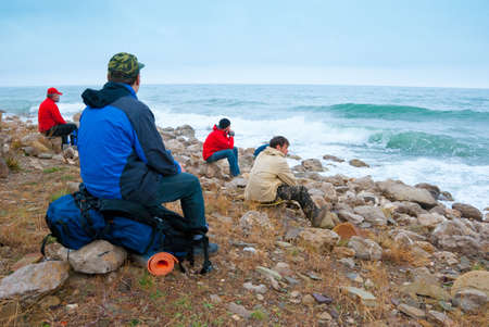 Hikers on a stony sea shore enjoys a landscape
の写真素材
