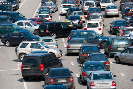 Traffic jam on the road, a lot of cars which go towards each other and to the different directions