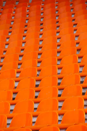 Orange empty stadium seatsの写真素材