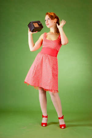 Pin-up style girl listening old radioの写真素材