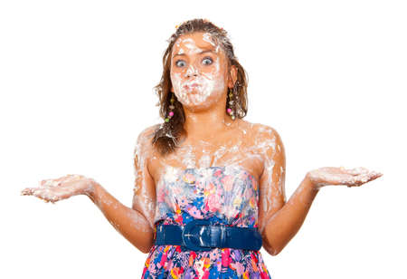 The girl had just eaten a cake with his hands, it is all dirty in the cream. の写真素材