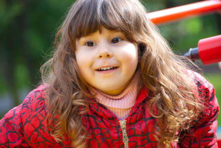 Little girl plays in playground in a park の写真素材