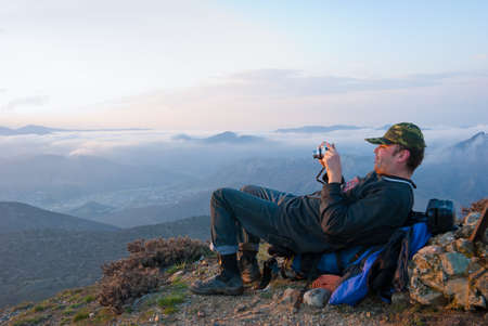 Hiker take a picture in mountainsの写真素材
