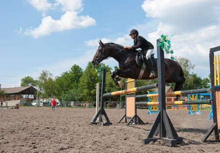 Jockey jumps over a hurdle at the competitionの写真素材