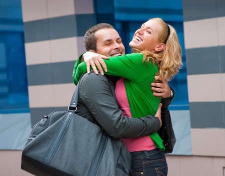Two attractive young people met in the street and they are happy