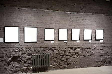 Empty frames on the brick wall in museum の写真素材
