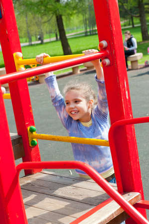 Girl having fun in playground in a park