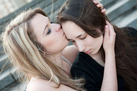 Two sad girls sorry for each other outdoorsの写真素材