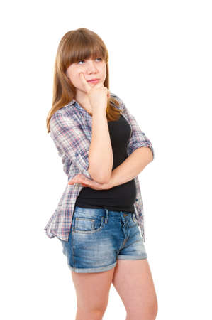 Teen girl thinks about something isloated over whiteの写真素材