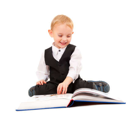 Little boy reading a book isolated on white background