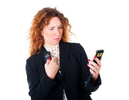 Young business woman with two mobile phones. Isolated over white background.
