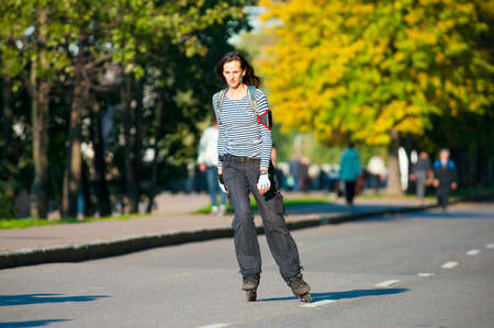 MOSCOW - SEPTEMBER 12: Girl roller-skating near Gorky Park on September 12, 2012 in Moscow. City government has built a new bicycle path on the embankment of the Moscow River for citizens recreation.のeditorial素材
