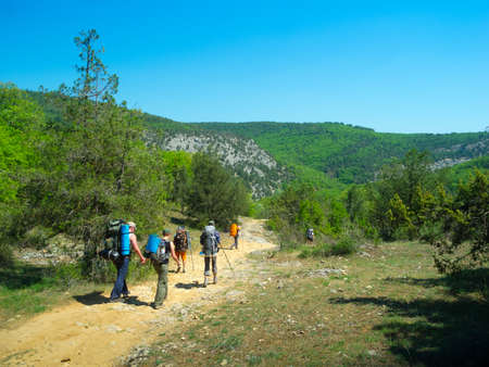 Hikers walk on a path in Crimea mountainsの写真素材