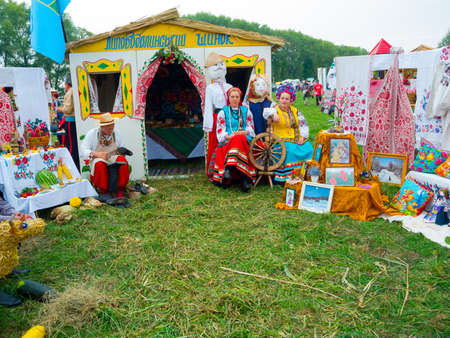 SUMY, UKRAINE - SEPTEMBER 22: Women wearing historical costume posing in traditional village background on annual agro exhibition SUMY-2012 on September 22, 2012 in Sumy, Ukraineのeditorial素材