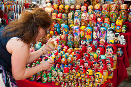 MOSCOW - JULY 26: Unidentified tourists choose a Matryoshka at the gift shop on July 26, 2012 in Moscow on Red Square. Nesting dolls are the most popular souvenirs from Russiaのeditorial素材