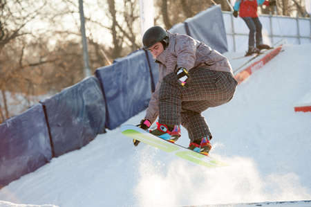MOSCOW - DECEMBER 16: Unidentified people ride a snowboard in Gorky Park on December 16, 2012 in Moscow. In recent years Gorky Park has been fully renovated to create a modern space for recreationのeditorial素材