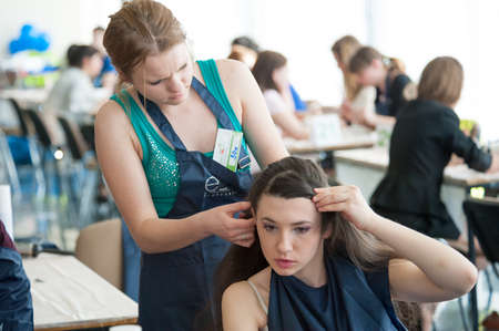 MOSCOW - APRIL 19: Unidentified orphan children, age 13-16, compete in hairdressing at the contest Young Master on April 19, 2013 in Moscow. Orphans were trained by charitable foundation Color of Lifeのeditorial素材