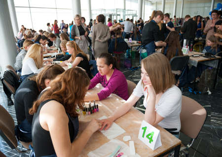 MOSCOW - APRIL 19: Unidentified orphan children, age 13-16, compete in manicure at the contest Young Master on April 19, 2013 in Moscow. Orphans were trained by charitable foundation Color of Lifeのeditorial素材