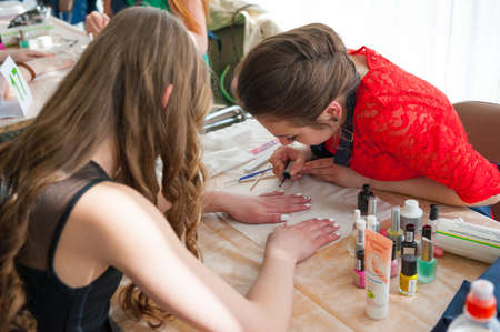 MOSCOW - APRIL 19: Unidentified orphan children, age 13-16, compete in manicure at the contest Young Master on April 19, 2013 in Moscow. Orphans were trained by charitable foundation Color of Lifeのeditorial素材