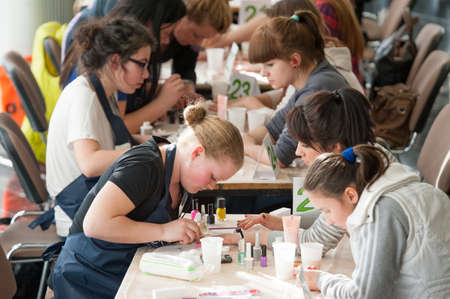 MOSCOW - APRIL 19: Unidentified orphan children, age 13-16, compete in manicure at the contest Young Master on April 19, 2013 in Moscow. Orphans were trained by charitable foundation Color of Lifeのeditorial素材