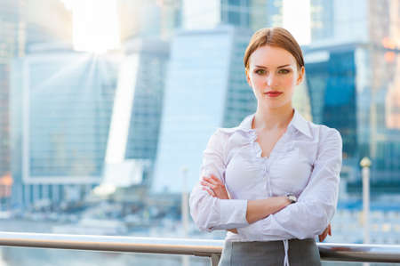 Young business woman on the modern city downtown backgroundの写真素材