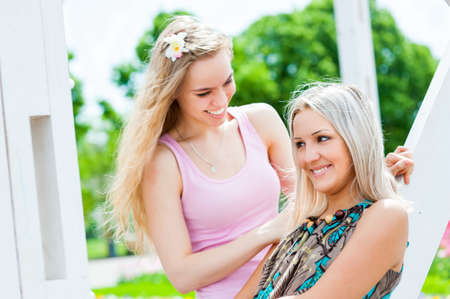 Two young women having fun outdoorsの写真素材