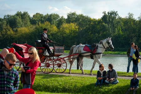 MOSCOW - SEPTEMBER 7: People ride in a carriage at Usadba Jazz Festival in Kuskovo Mansion on September 7, 2013 in Moscow. This festival was held on the Day of Moscow and was free to visitのeditorial素材