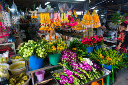MAEKLONG, THAILAND - MARCH 24: Vendor sells fresh local agricultural production on March 24, 2014 in famous Maeklong Railway Market also known as Talad Rom Hub or Umbrella Pulldown Marketのeditorial素材